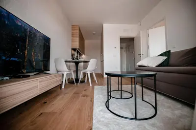 a living room with two tables and a large tv at Apartma 2+2 v mestu Ljubljana (V325) in Ljubljana