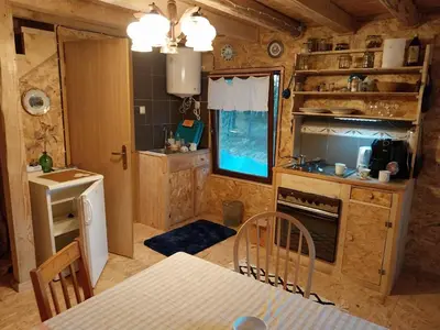a kitchen with a table and a dining room at Cowboy House at Ranch Lambergar in Gabrovka