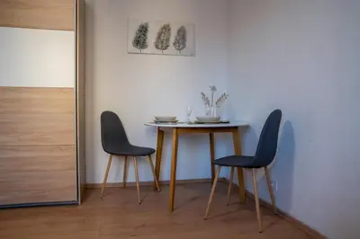 a dining room with a table and two chairs at Small but cozy apartment in Maribor