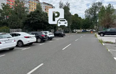 a parking lot with cars parked on the road at Small but cozy apartment in Maribor