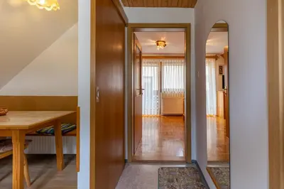 a hallway with a door leading to a dining room at Apartment Vidmar in Bohinj