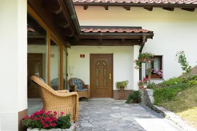 a porch of a house with a wooden door at At Peskar's a charming countryside house in Podbrdo