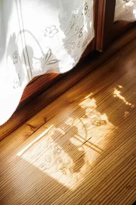 a book laying on top of a wooden floor at Country House Lastovka in Tolmin