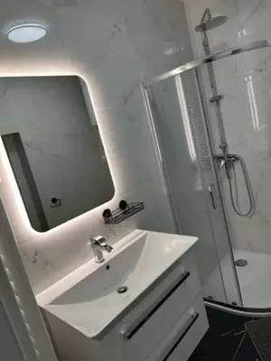 a bathroom with a sink and a shower and a mirror at Gostilna in apartmaji Zlati lev - Maribor in Maribor