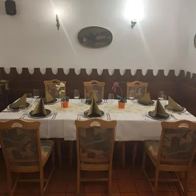 a table in a restaurant with a white table cloth at Gostilna in apartmaji Zlati lev - Maribor in Maribor