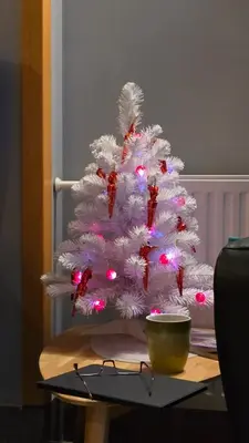 a white christmas tree sitting on top of a table at Hotel GH Kolinska in Bled
