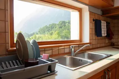 a kitchen with a sink and a window at Apartma Burk in Kobarid