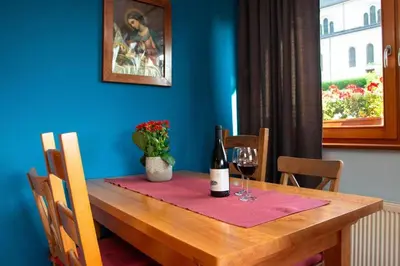 a table with a bottle of wine and two glasses at Apartma Burk in Kobarid