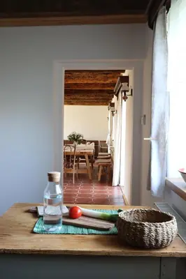 a kitchen counter with a table with a basket on it at Hiška pod Klumpo in Ormoz