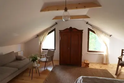a living room with a couch and a table at Hiška pod Klumpo in Ormoz