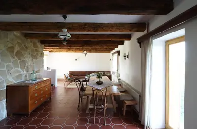 a kitchen and dining room with a table and chairs at Hiška pod Klumpo in Ormoz