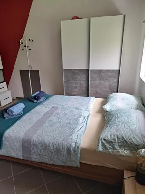a bedroom with a bed and a lamp in it at Pri Ani Ruscovi in Bovec