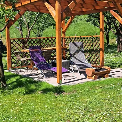 two chairs sitting on a patio under a gazebo at Pri Ani Ruscovi in Bovec