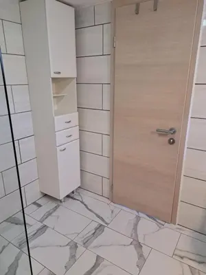 a room with a door and a tile wall at Pri Ani Ruscovi in Bovec
