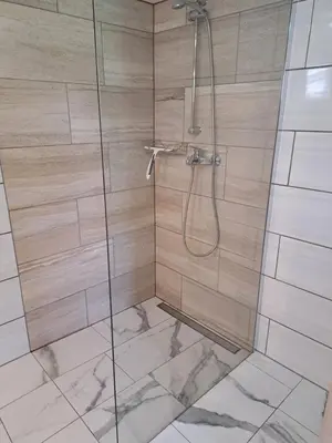 a bathroom with a shower with a glass door at Pri Ani Ruscovi in Bovec