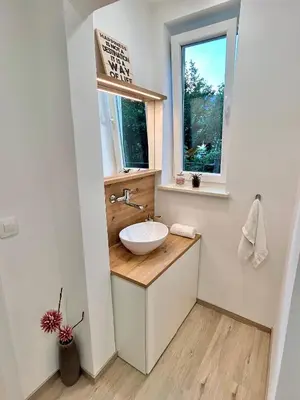 a bathroom with a sink and a window at Creekside House K in Mozirje