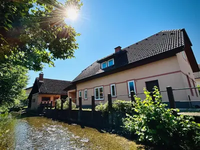 a house next to a river at Creekside House K in Mozirje