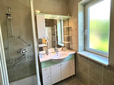 a bathroom with a sink and a shower at Creekside House K in Mozirje