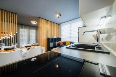a kitchen with a sink and a table with chairs at Cosy apartment in Divača