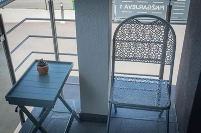 a blue table and a chair next to a window at Cuckoo's Alpine Nest in Lesce