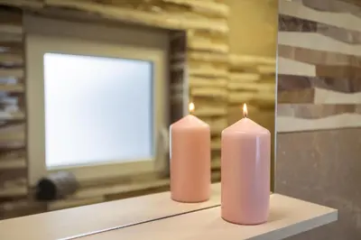 two pink candles sitting on a table in front of a window at Cuckoo's Alpine Nest in Lesce