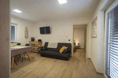 a living room with a couch and a table at Cuckoo's Alpine Nest in Lesce