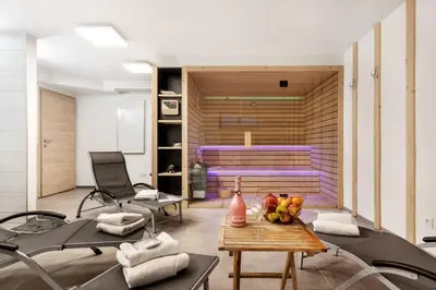 a room with a gym with chairs and a table at Chic Apartments with Finnish Sauna and Jacuzzi in Kranjska Gora
