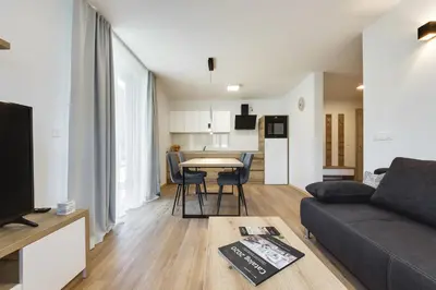 a living room with a couch and a table at Chic Apartments with Finnish Sauna and Jacuzzi in Kranjska Gora