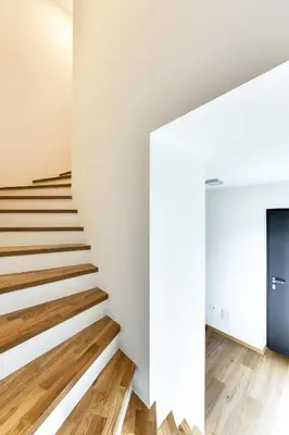 a staircase in a house with white walls and wooden floors at Chic Apartments with Finnish Sauna and Jacuzzi in Kranjska Gora