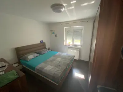 a small bedroom with a bed and a window at Apartma Mira in Zgornje Škofije