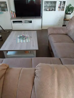 a living room with a couch and a coffee table at Apartma Mira in Zgornje Škofije
