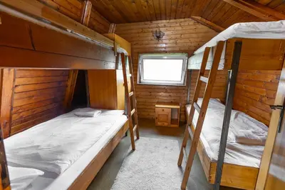 a bedroom with two bunk beds in a cabin at Cosy countryside cottage with indoor fireplace in Sodražica