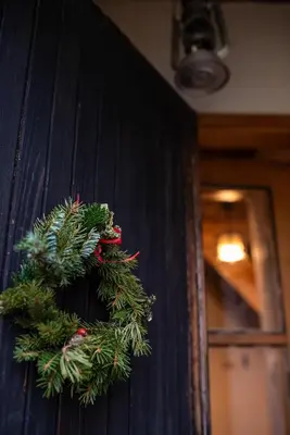 a christmas wreath is hanging on a wall at Cosy countryside cottage with indoor fireplace in Sodražica