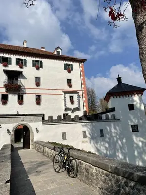 a bike parked in front of a building at Cosy countryside cottage with indoor fireplace in Sodražica