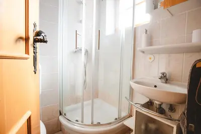 a bathroom with a shower and a sink at POČITNIŠKI APARTMAJI - Vijolica 2 in Moravske Toplice in Moravske Toplice