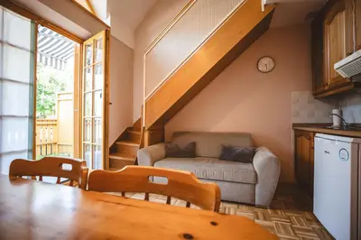 a living room with a couch and a table at POČITNIŠKI APARTMAJI - Vijolica 2 in Moravske Toplice in Moravske Toplice