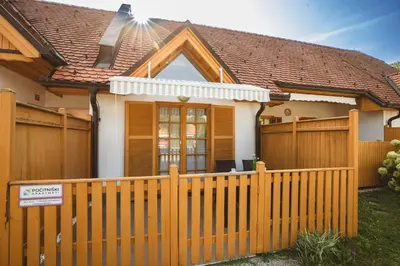 a wooden fence in front of a house at POČITNIŠKI APARTMAJI - Vijolica 2 in Moravske Toplice in Moravske Toplice