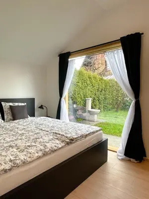 a bedroom with a bed and a large window at Lodge Pia in Bled
