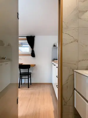 a small kitchen with a table and a dining room at Lodge Pia in Bled