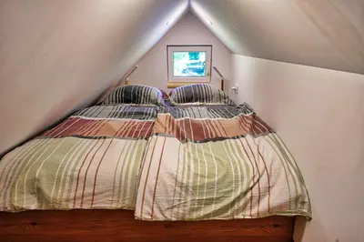 a bedroom with a bed in a attic at Betlehem Resort in Zgornje Gorje