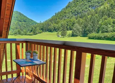 a table on a balcony with a view of a mountain at Betlehem Resort in Zgornje Gorje