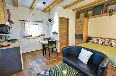a room with a bed and a couch and a table at Betlehem Resort in Zgornje Gorje