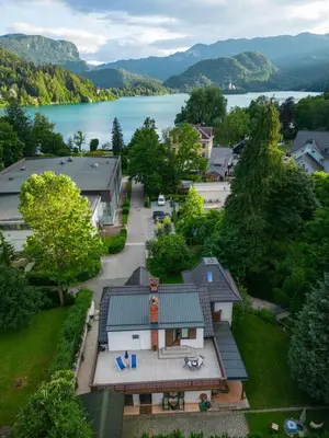 an aerial view of a house with a lake at UpArt Bled in Bled