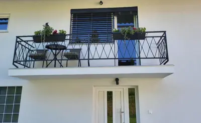 a balcony with potted plants on a building at Under The Castle in Dob