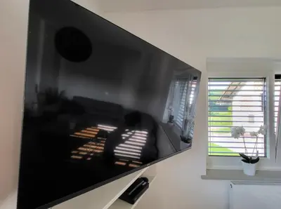 a person sitting on a couch in a living room at Under The Castle in Dob