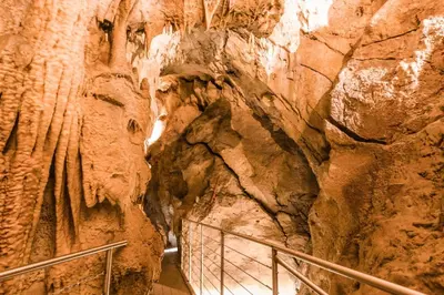 a staircase in a cave with a rock wall at Under The Castle in Dob
