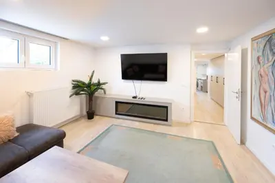 a living room with a couch and a flat screen tv at The Nice Apartment in Domžale