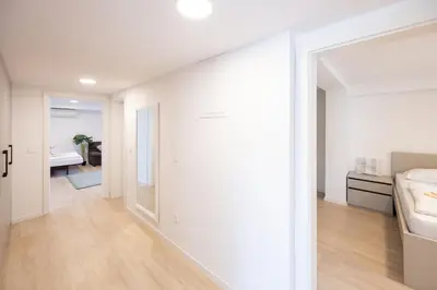 a bedroom with white walls and a sliding glass door at The Nice Apartment in Domžale