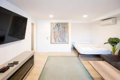 a living room with a couch and a bed at The Nice Apartment in Domžale