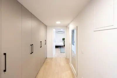 a hallway of a house with white walls and wooden floors at The Nice Apartment in Domžale